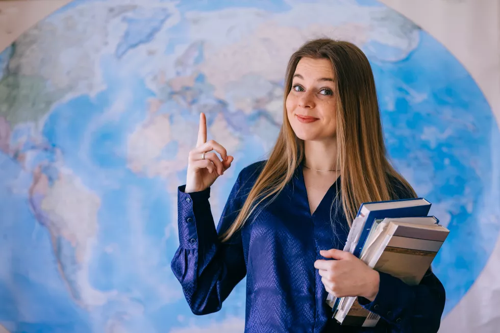 happy-student-with-world-map-wall(1)